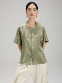Front view of the Sage Green Jacquard Mandarin Collar Blouse by Gambiered Silk featuring a relaxed fit and decorative frog buttons.