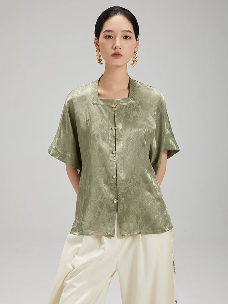 Front view of the Sage Green Jacquard Mandarin Collar Blouse by Gambiered Silk featuring a relaxed fit and decorative frog buttons.