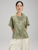 Front view of the Sage Green Jacquard Mandarin Collar Blouse by Gambiered Silk featuring a relaxed fit and decorative frog buttons.