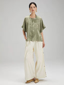 Full outfit featuring the Sage Green Jacquard Mandarin Collar Blouse paired with wide-leg trousers.
