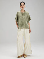 Full outfit featuring the Sage Green Jacquard Mandarin Collar Blouse paired with wide-leg trousers.