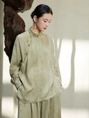 Close-up of the Sage Green Mandarin Collar Lyocell Blend Blouse highlighting the jacquard texture, mandarin collar and handcrafted frog buttons.