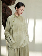 Close-up of the Sage Green Mandarin Collar Lyocell Blend Blouse highlighting the jacquard texture, mandarin collar and handcrafted frog buttons.
