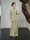 Lifestyle view of the Sage Green Mandarin Collar Lyocell Blend Blouse showcasing its relaxed silhouette and timeless oriental-inspired design.