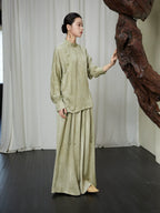 Lifestyle view of the Sage Green Mandarin Collar Lyocell Blend Blouse showcasing its relaxed silhouette and timeless oriental-inspired design.