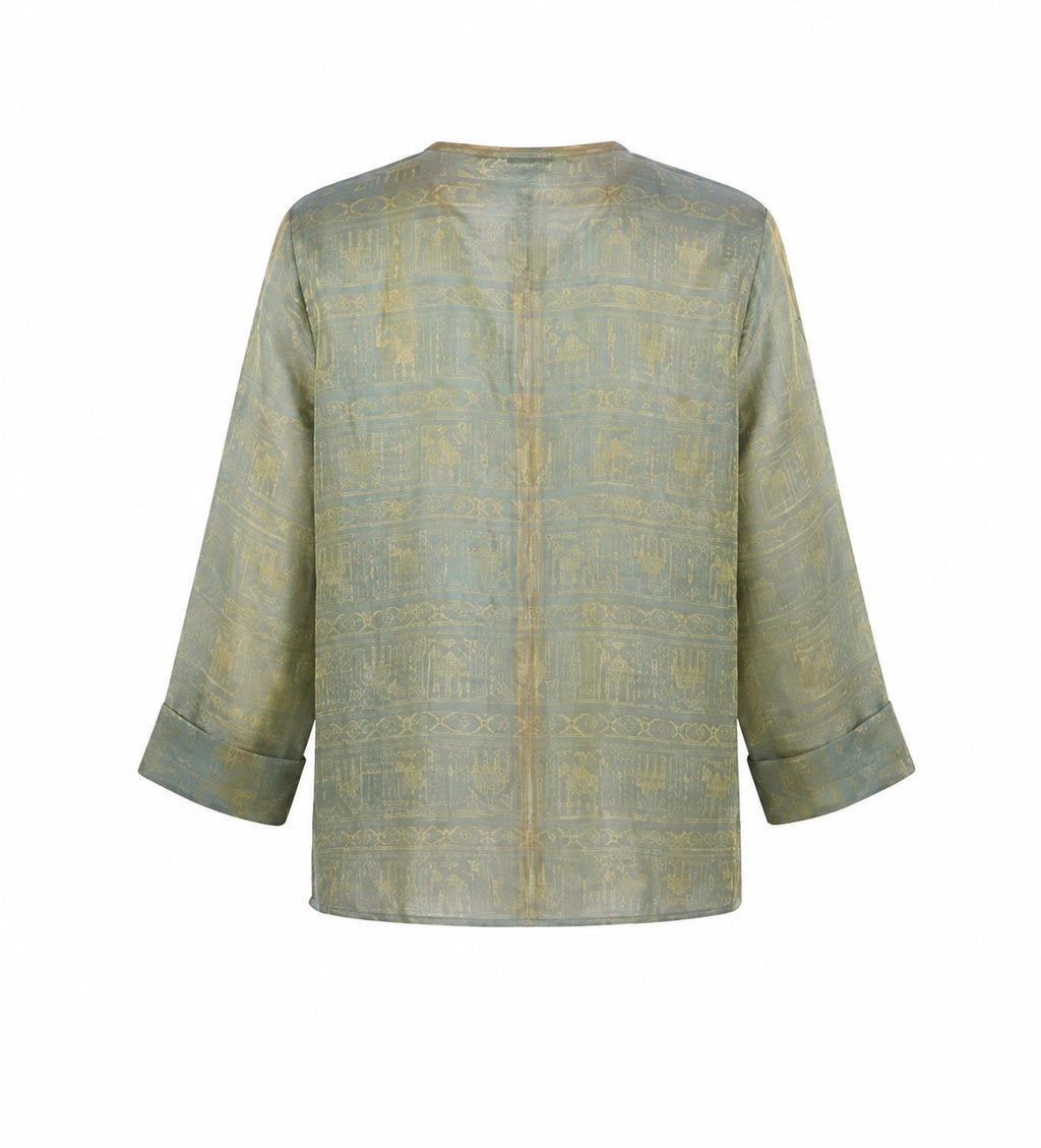 Back view of a sage green Chinese-inspired silk jacket with geometric woven pattern