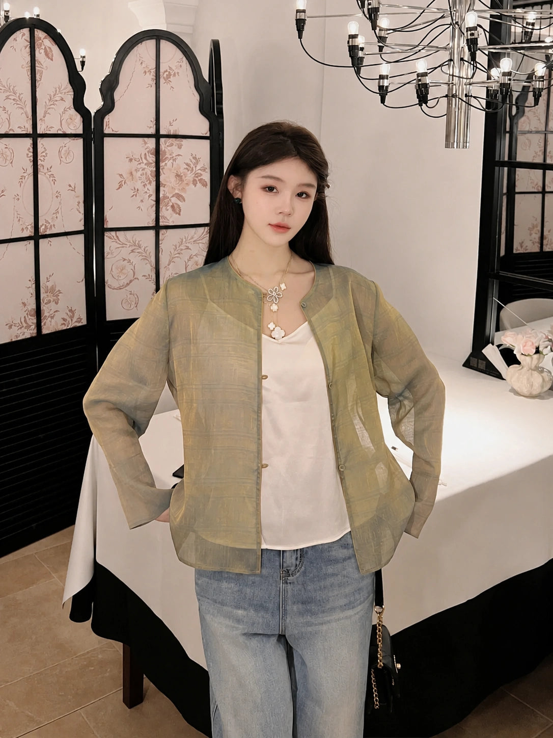 Model wearing a relaxed sage green mulberry silk jacket with a patterned finish
