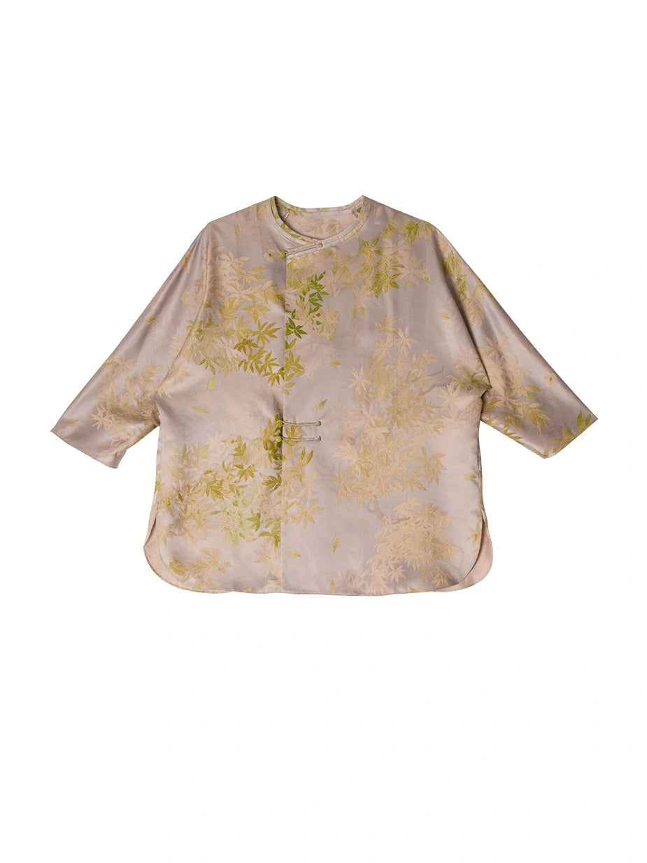 Front product view of a taupe mulberry silk blouse with green leaf print, three-quarter sleeves and asymmetric closures