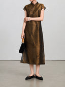 Styled view of the silk-blend qipao showing its stand collar, butterfly motifs and fine shimmer