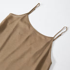 Close-up of the smooth bronze-brown slip dress and its adjustable spaghetti straps