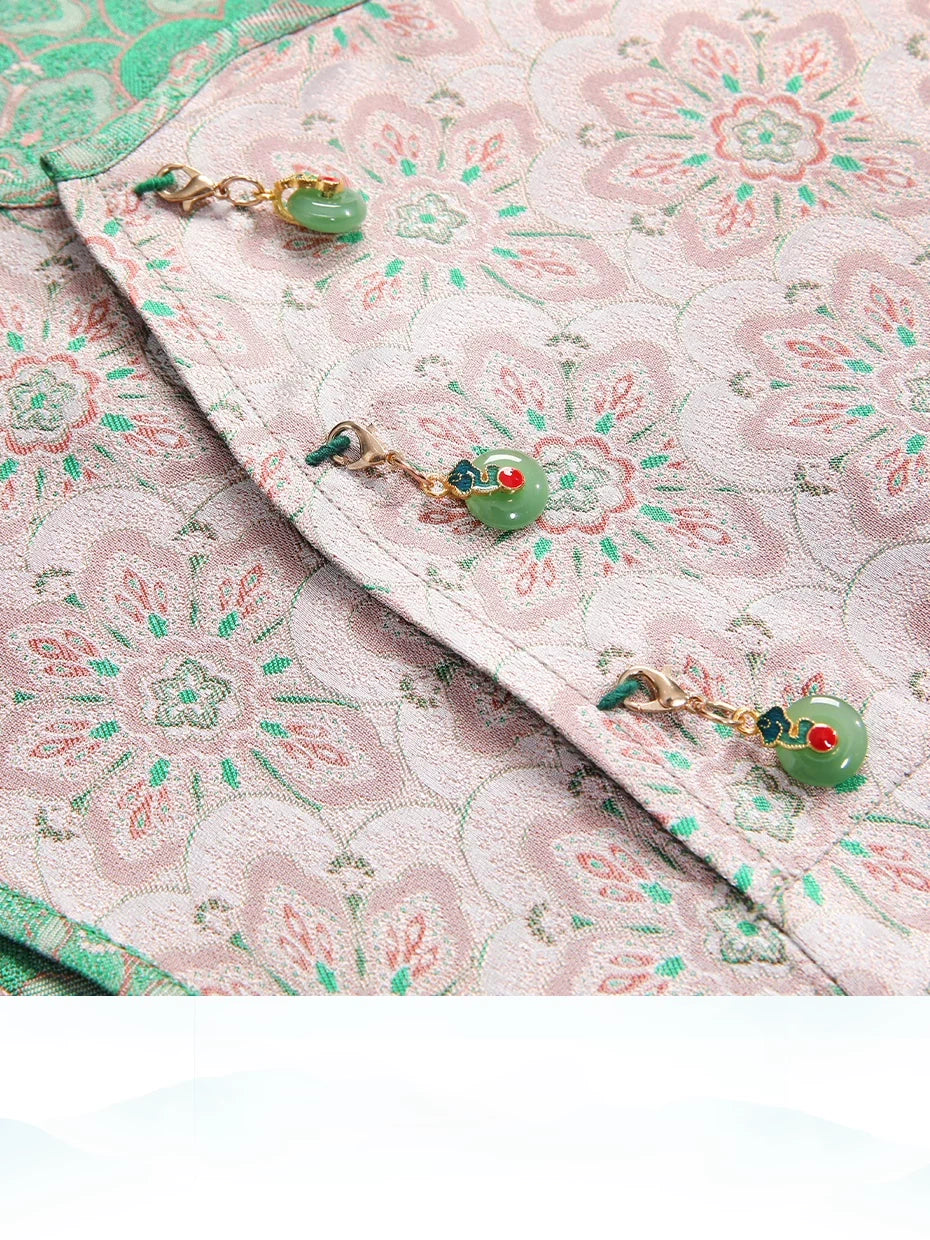 Jade-inspired charm buttons on the pink floral Song brocade silk dress.