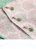 Jade-inspired charm buttons on the pink floral Song brocade silk dress.