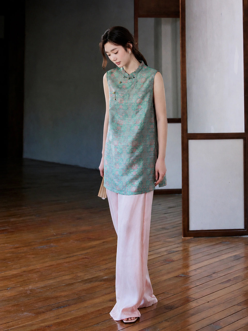 Front view of the teal Song brocade vest with a stand collar and asymmetrical knot buttons