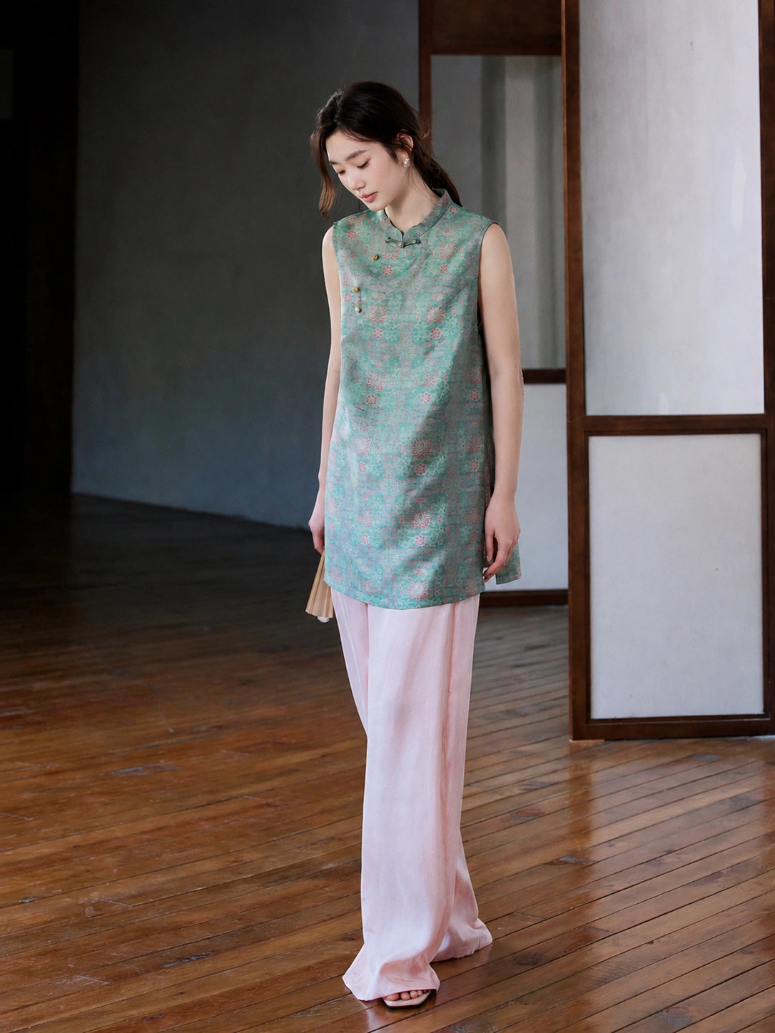 Front view of the teal Song brocade vest with a stand collar and asymmetrical knot buttons