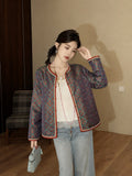 Model wearing a fitted teal silk autumn jacket with traditional Chinese-inspired detailing