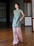 Full-length styled view of the teal jacquard longline vest worn with flowing pink trousers