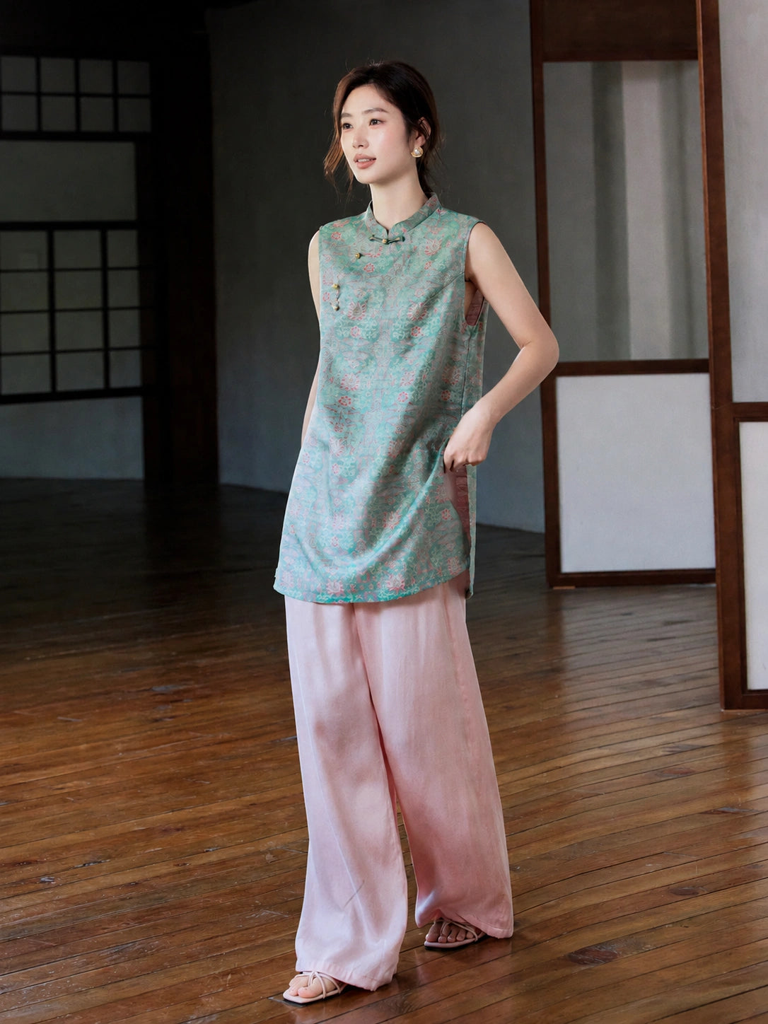 Full-length styled view of the teal jacquard longline vest worn with flowing pink trousers