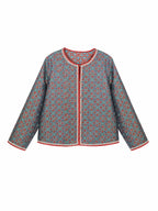 Front view of a teal patterned mulberry silk jacket with contrasting red trim