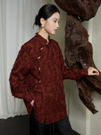 Three-quarter side view of the burgundy textured Mandarin collar blouse featuring a relaxed silhouette and asymmetrical frog-button closure.