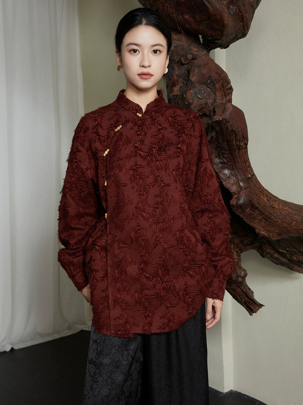 Front view of the Textured Mandarin Collar Cotton Blend Blouse by Gambiered Silk in burgundy with traditional frog-button detailing.