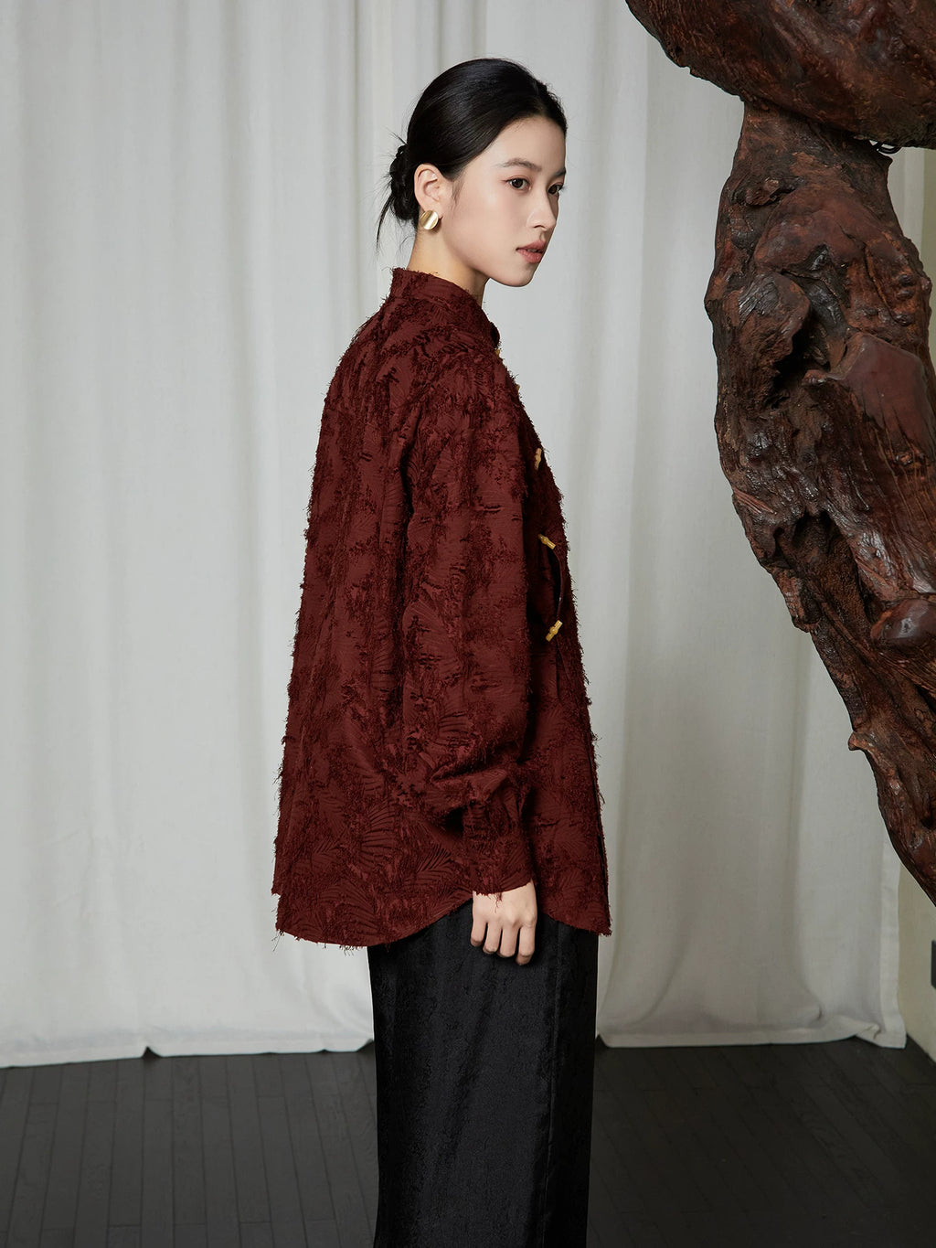Side profile of the Textured Mandarin Collar Cotton Blend Blouse highlighting the loose fit and textured woven fabric.