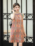Front model view of a vermilion multicolor Shu brocade dress with a relaxed H-line silhouette.