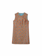 Front product view of a vermilion sleeveless Shu brocade silk dress with geometric medallion motifs.