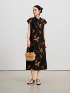 Model wearing a black mulberry silk Xiangyunsha A-line dress with a woven handbag