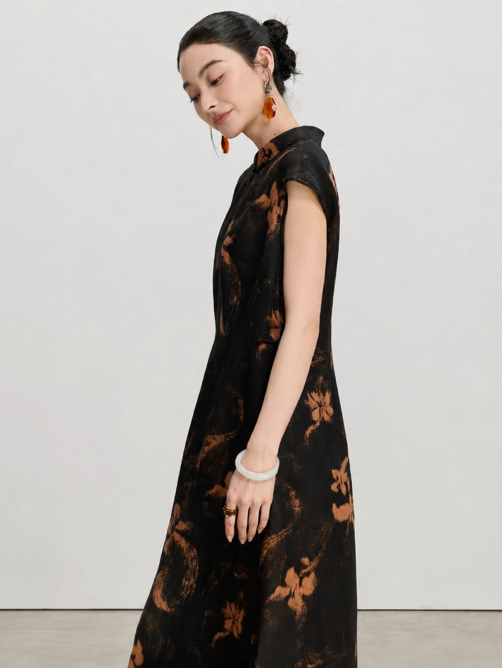 Side view showing the relaxed silhouette of the black Xiangyunsha silk A-line dress