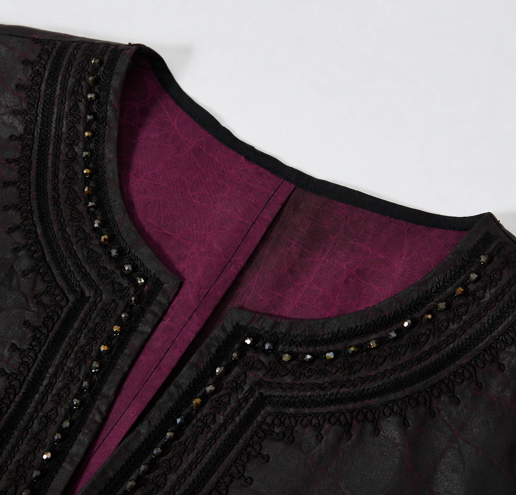 Close-up of the black braided embroidery, faceted beads and purple interior at the V-neckline