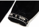 Close-up of the embroidered cuff on the black velvet sleeve