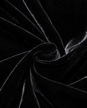 Close-up of the black velvet fabric and its light-catching texture
