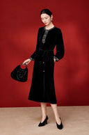 Three-quarter full-length view showing the dress’s long sleeves and flared skirt
