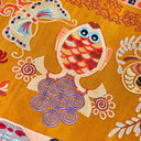 Close-up of colorful bird and butterfly embroidery on Gilded Ochre silk