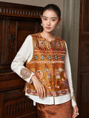 Front styling view of the Gilded Ochre silk vest with a white blouse