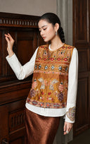 Model looking down while wearing the Gilded Ochre embroidered vest