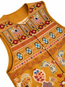 Close-up of the Gilded Ochre vest neckline and geometric embroidery
