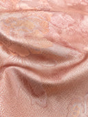 Close-up of the rose-peach fabric showing its lustrous floral jacquard texture