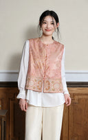 Front view of the Gilded Peach Mist vest styled over a white blouse