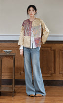 Full-length model look with the plum and apricot patchwork jacket layered over a white shirt and jeans.