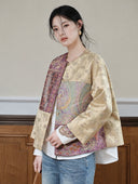 Model wearing the plum and apricot jacket, showing its contrasting front panels and wide sleeves.