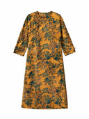 Close-up of the floral print and handcrafted frog button on a mulberry silk dress
