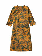 Close-up of the floral print and handcrafted frog button on a mulberry silk dress