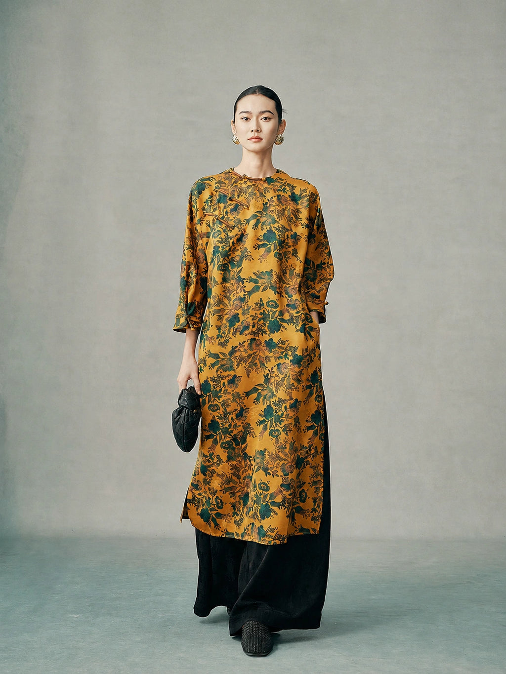 Model wearing a gold floral 100% mulberry silk cheongsam dress