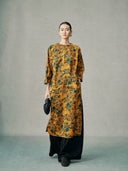 Model wearing a gold floral 100% mulberry silk cheongsam dress