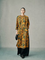 Model wearing a gold floral 100% mulberry silk cheongsam dress