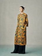 Side view of a gold floral mulberry silk cheongsam dress