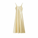 Flat lay of a champagne gold satin slip dress with metallic strap details and a lustrous finish, 100% polyester material.