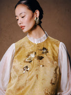 Close-up of the floral sequin embroidery and jacquard texture on the Gambiered Silk silk blend vest.