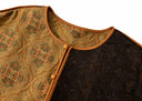 Close-up of the round neckline, brown piping and button-and-loop closure